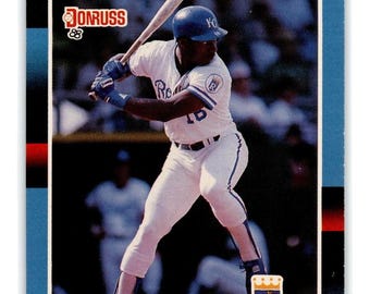 May include: A baseball card featuring Bo Jackson of the Kansas City Royals. The card has a blue border with red accents and the Donruss '88 logo. Jackson is in a batting stance, wearing a white uniform with blue trim and the Royals logo.