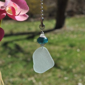 May include: A white sea glass fan pull with a teal blue glass bead and silver chain.