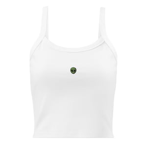 Op de afbeelding: Witte crop top met dunne bandjes en een ronde halslijn. De top heeft een kleine, groene alienkop geborduurd op de voorkant. De tanktop is gemaakt van zacht, geribbeld materiaal.