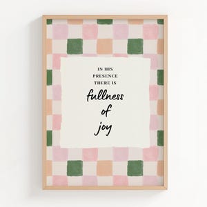 May include: Framed art print with a checkered pattern in pink, green, and peach. The artwork features the text "IN HIS PRESENCE THERE IS fullness of joy" in a handwritten style, set against a cream-colored background.