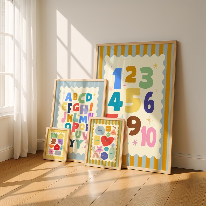 May include: Four framed art prints with colorful designs. One print features the numbers 1-10, another the alphabet, and a third with shapes and a heart. The smallest print has a house and other shapes.