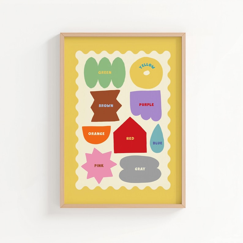 May include: A framed art print featuring colorful shapes and the names of colors. The shapes include a green clover, a brown bow tie, an orange half-circle, a pink star, a yellow circle, a purple scalloped shape, a red house, a blue teardrop, and a gray cloud.