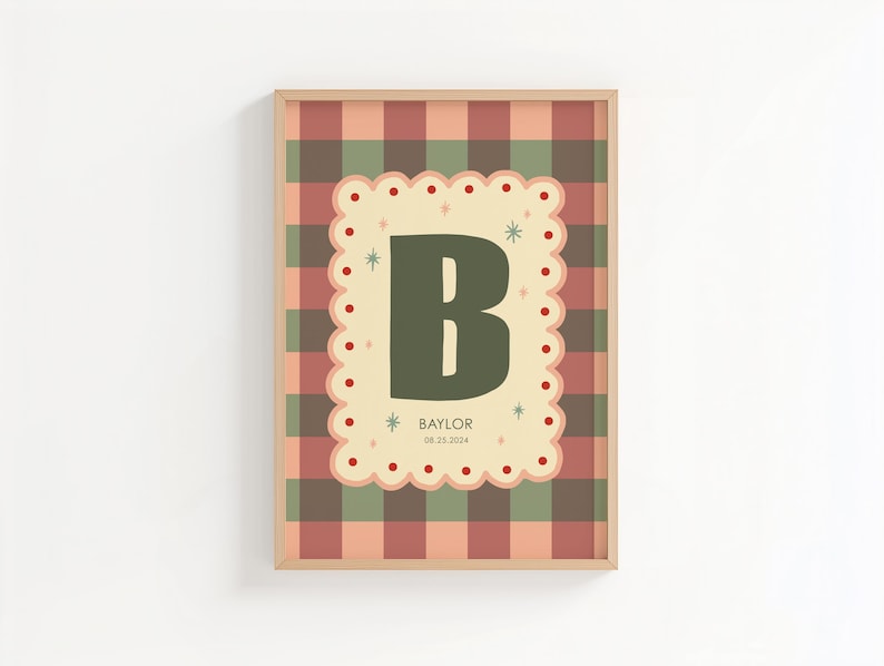 Puede incluir: Un estampado enmarcado con una gran letra "B" verde sobre un fondo crema festoneado. El fondo es un patr&oacute;n de cuadros en tonos rojos, verdes y beige. El nombre "Baylor" y la fecha est&aacute;n impresos debajo.