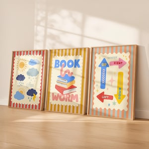 May include: Three framed art prints with colorful illustrations. One features weather icons, another has a stack of books with a worm and the text "BOOK WORM", and the last has directional arrows with the words "UP", "DOWN", "LEFT", and "RIGHT".