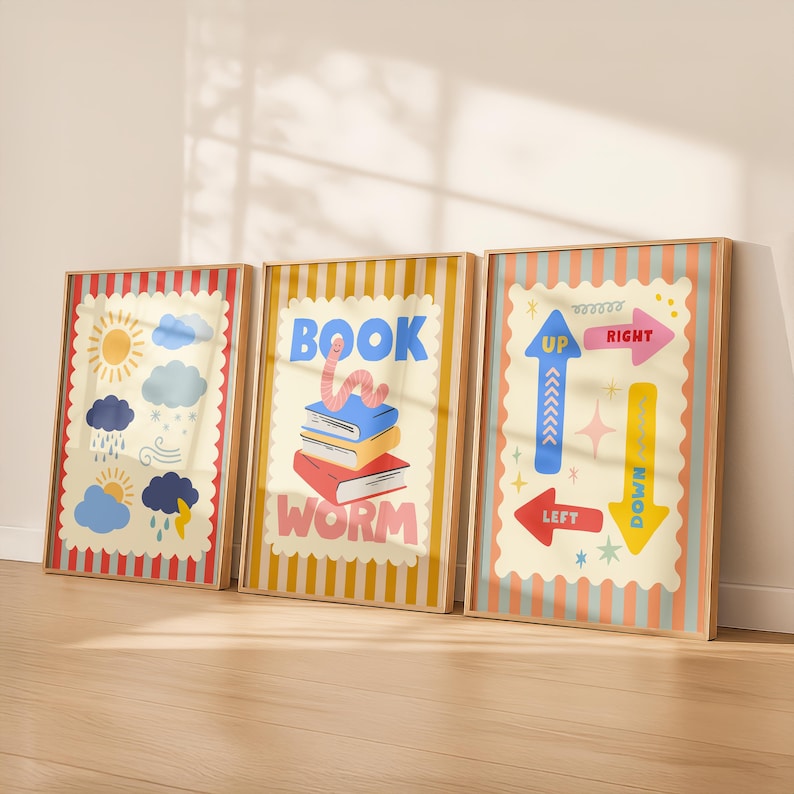 May include: Three framed art prints with colorful illustrations. One features weather icons, another has a stack of books with a worm and the text "BOOK WORM", and the last has directional arrows with the words "UP", "DOWN", "LEFT", and "RIGHT".