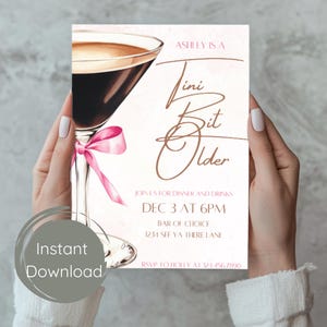 May include: A party invitation with a martini glass illustration and the text "Ashley is a Tiny Bit Older." The invitation includes details for dinner and drinks on December 3rd at 6 PM. A pink bow adorns the martini glass.