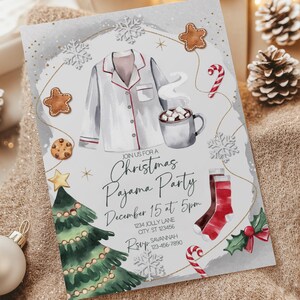 May include: A Christmas Pajama Party invitation with watercolor illustrations. The design features a pajama top, a mug of hot cocoa, gingerbread cookies, a Christmas tree, and a stocking. The invitation includes the text "Join us for a Christmas Pajama Party".