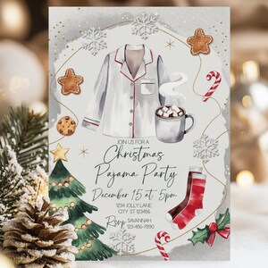 May include: A Christmas Pajama Party invitation with watercolor illustrations. The design features a white pajama top, a mug of hot cocoa, gingerbread cookies, candy canes, and a Christmas tree. The invitation text reads "Join us for a Christmas Pajama Party".