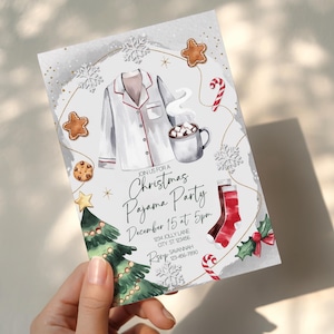 May include: A Christmas Pajama Party invitation card. The watercolor design features a white pajama top with red trim, a mug of hot cocoa, gingerbread cookies, and a Christmas tree. The invitation text reads "Join us for a Christmas Pajama Party".