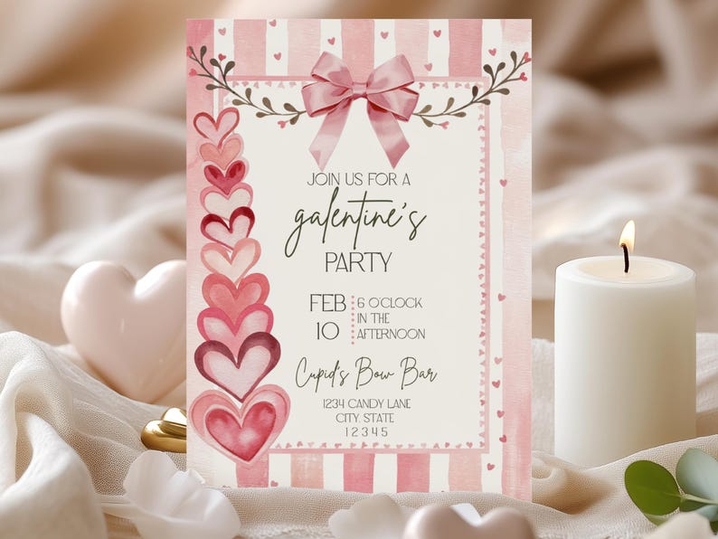 May include: A pink and white Galentine's Party invitation with a bow and hearts. The invitation includes the text "Join us for a Galentine's Party" and event details. A lit white candle and heart-shaped decorations are in the foreground.