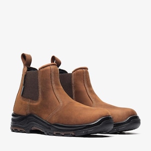 May include: A pair of brown leather work boots with black soles. The boots have a pull tab at the back and elastic side panels for easy wear. The soles are thick and durable, designed for safety and support.