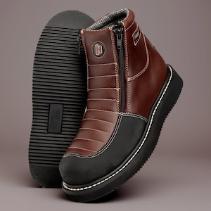 May include: Brown leather ankle boots with a black sole and toe. The boots have a side zipper, white stitching, and a padded collar. The sole of one boot is visible next to the other.