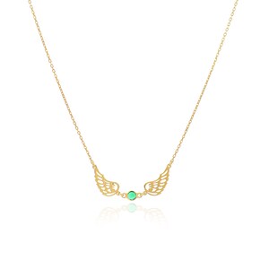 May include: A gold-colored necklace featuring a pair of openwork wings on either side of a small, round, green gemstone. The necklace chain is delicate and thin, and the wings have intricate detailing.