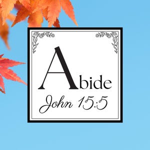 May include: A square white graphic with the word "Abide" and the text "John 15:5" in black script. The graphic is framed in black with floral corner accents. The background is a light blue with orange and yellow leaves.