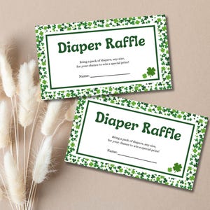 May include: Two white cards with green shamrock borders. The text "Diaper Raffle" is in green on each card. The text "Bring a pack of diapers, any size, for your chance to win a special prize!" is on each card. There is a line for a name on each card.