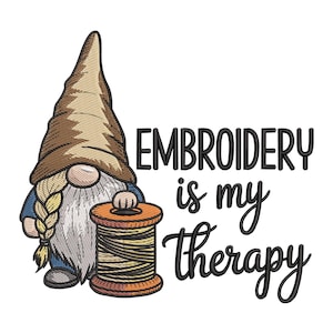 May include: A whimsical illustration features a gnome with a long white beard, a pointed brown hat, and a blue jacket, holding a spool of thread. The text "EMBROIDERY is my therapy" is written in black script. The image is set against a white background.