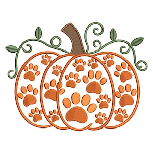 May include: An orange pumpkin design with paw prints, a brown stem, and green vines and leaves. The pumpkin is divided into three sections, each filled with various sizes of orange paw prints.