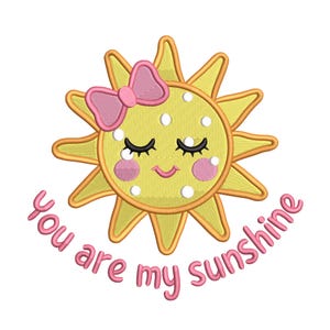 May include: Embroidered design of a smiling sun with closed eyes, a pink bow, and rosy cheeks. The sun is yellow with white polka dots and a gold outline. The text "You are my sunshine" is in pink script.