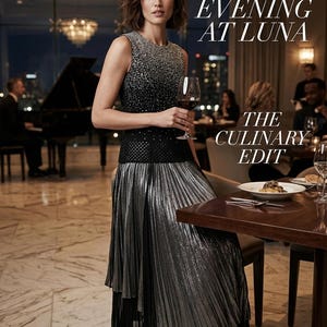 May include: A woman in a formal dress holding a glass of red wine. The sleeveless dress has a beaded bodice and a pleated silver skirt. The text reads "An Evening at Luna" and "The Culinary Edit". The brand name "St. John" is also visible.
