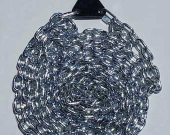 May include: A silver chain with a black plastic hook. The chain is coiled up and ready to be used.