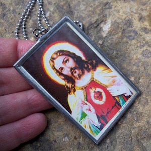 Kitsch Vintage 1980's Large Jesus Pendant on the back of Mexican Carta Blanca Beer Tin
