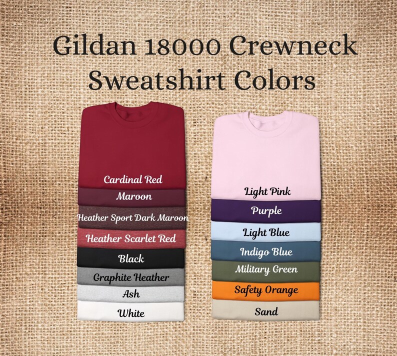May include: Image showing a selection of Gildan 18000 crewneck sweatshirt colors. Colors include Cardinal Red, Maroon, Heather Sport Dark Maroon, Heather Scarlet Red, Black, Graphite Heather, Ash, White, Light Pink, Purple, Light Blue, Indigo Blue, Military Green, Safety Orange, and Sand.