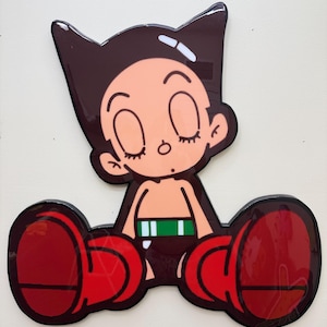 May include: A cartoon-style image of a character with large red boots, a green belt, and a brown helmet-like hair. The character has closed eyes and a peach skin tone. The image has a glossy finish and is mounted on a white background.