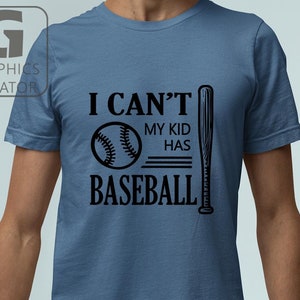 May include: A blue t-shirt featuring the black text "I CAN'T MY KID HAS BASEBALL". The design includes a baseball and a bat. The shirt is a solid colour and likely made of cotton.