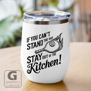 Könnte beinhalten: Weißer isolierter Becher mit einem durchsichtigen Deckel. Der Becher hat einen schwarzen Text mit der Aufschrift "IF YOU CAN'T STAND THE HEAT STAY OUT OF THE Kitchen!" mit einer Grafik eines brennenden Pickleball-Schlägers. Das Graphics Curator-Logo befindet sich unten links.