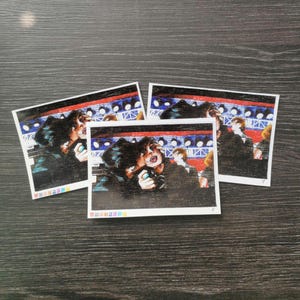 May include: Three black and white illustrations of people in a concert setting. The illustrations are printed on white card stock.