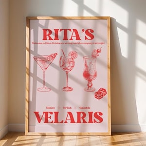 May include: A pink poster with the text "Rita's" in red, with the words "Welcome to Rita's. Drinks are strong and the company is stronger" in smaller red text. The poster features three red illustrations of cocktails, with the words "Dance", "Drink", and "Games" below the illustrations. The poster also has the text "Velaris" in large red letters at the bottom.