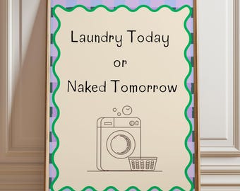May include: Framed wall art with the text "Laundry Today or Naked Tomorrow." The artwork features a beige background with a black and white illustration of a washing machine and laundry basket. The frame has a green and purple wavy border.