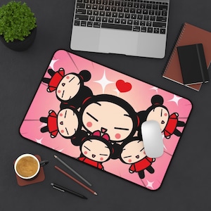 May include: A rectangular mousepad featuring a cartoon design with a pink background and a central image of a character surrounded by smaller versions of itself. The character is wearing a red outfit and has black hair. A white mouse sits on the pad.
