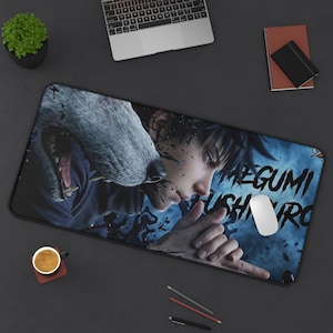 May include: A rectangular mousepad featuring a detailed illustration of a character with a wolf and the text "MEGUMI FUSHIGURO" in white. The background is blue with black ink splatters. A white mouse is on the right.