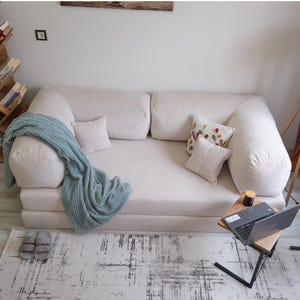 Teddy sofa bed styled in lounge and bed modes, providing multifunctional comfort and cozy elegance for family homes.