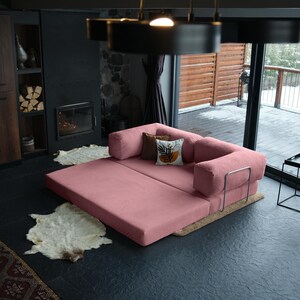 Plush teddy closed corner couch displayed with rugs and throws, providing a stylish and inviting setup.