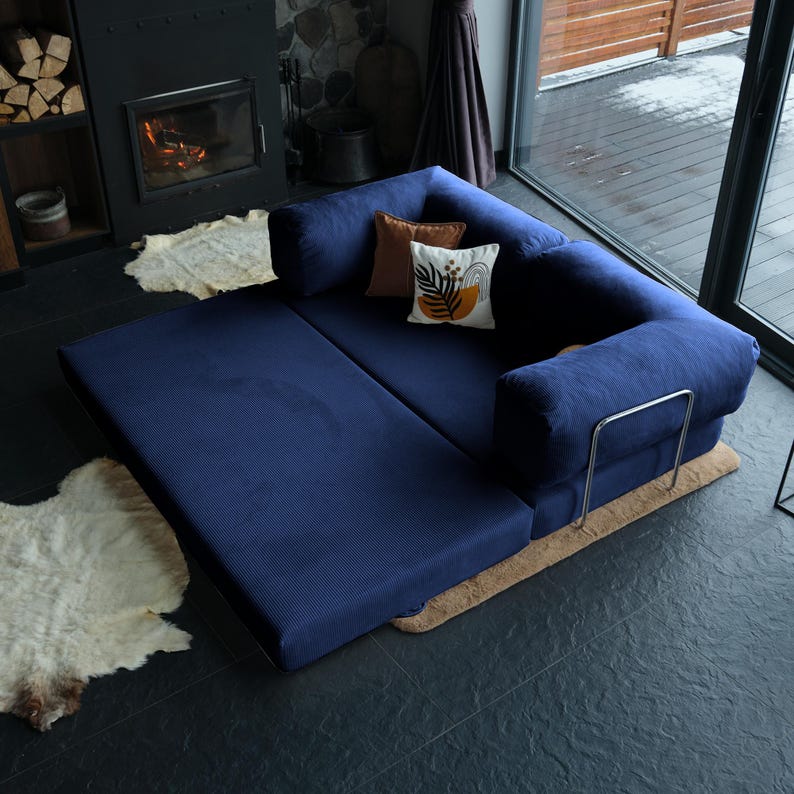 Closed sleeper teddy sofa bed in warm beige corduroy with layered pillows, turning any corner into a quiet retreat or functional guest zone.