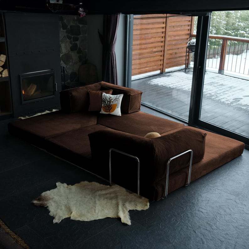 Cozy sleeper couch styled low to the ground, offering multifunctional use and a relaxed family-friendly atmosphere.