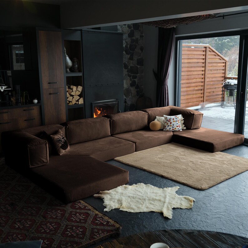 Minimalist comfy sectional displayed with rugs and throws, providing warmth, softness, and versatile everyday use.