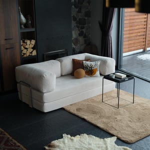 Livingroom traditional corner sofa arranged with layered cushions, offering timeless design and inviting comfort.