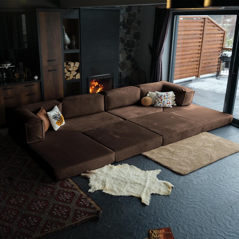 Washable livingroom sofa arranged with layered pillows, blending durability, comfort, and elegant minimalist design.