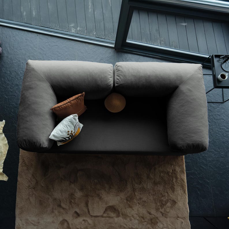 Traditional floor teddy sofa styled in a serene corner with layered textiles, creating a nostalgic space where soft comfort and grounded living meet.