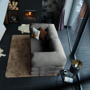 Folded sofa modules arranged in a corner setup, showing the adaptability of this washable teddy couch from lounge to sleep surface in minutes.