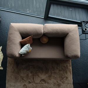 Modular corduroy teddy sofa displayed with layered throws, combining textured durability with soft elegance.