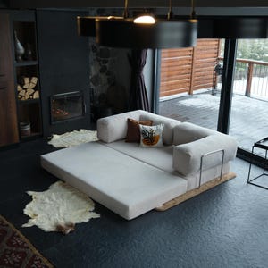 Plush teddy sectional sofa arranged with rugs and throws, creating a warm and elegant livingroom centerpiece.