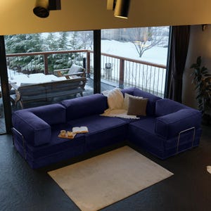This teddy-inspired floor sofa bed offers modular design and washable covers, perfect for a cozy and practical living room couch with soft, plush texture.