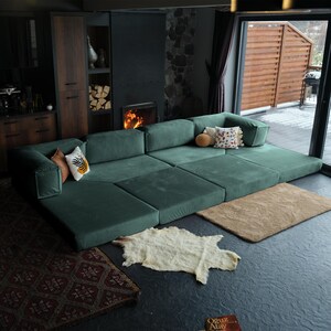 Soft teddy sofa arranged with rugs and throws, combining plush texture and cozy sophistication for contemporary interiors.