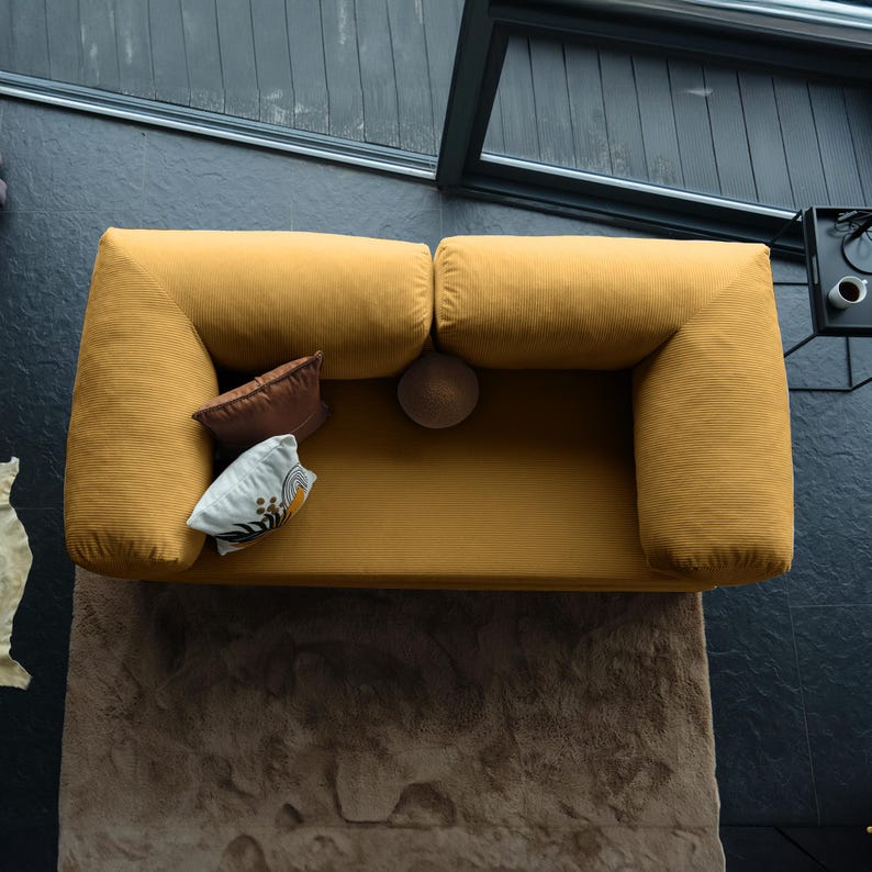 Corduroy teddy couch arranged in natural tones, offering durable practicality and soft comfort for family livingrooms.