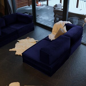 Modular, washable, and soft teddy fabric make this floor sofa bed a perfect living room couch for comfortable lounging and sleeping.