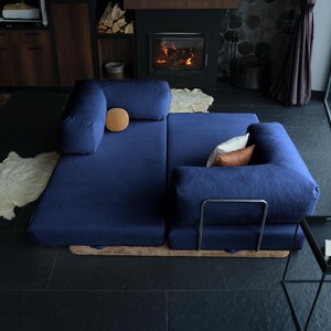 Corduroy foldable sofa styled as a compact guest bed in a minimal interior, showing how small-space living can still be cozy, stylish, and sleep-ready.